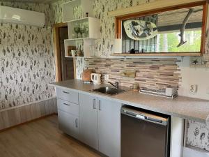 a kitchen with a sink and a counter top at sun& relax- TINYHOUSE in Sõitme