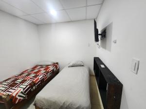 a bedroom with a bed and a dresser in it at Depamedios4 in San Cayetano