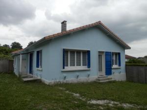 a blue house with blue windows and a grass field at L'épine bleue in Richemont