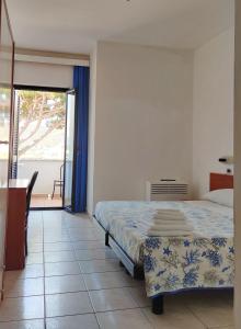 Postel nebo postele na pokoji v ubytování Hotel Stella del Tirreno