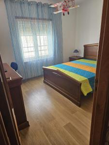 a bedroom with a bed and a window at BigWaves2 in Nazaré +6 photos