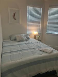 a bedroom with a large bed with two towels on it at The Clement Chateau - Brand New Home in Missouri City