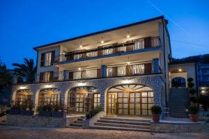 a large building with a balcony on top of it at Villa Klarić - Bed & Breakfast in Lovran