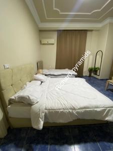 Krevet ili kreveti u jedinici u objektu Richard Pyramids inn hotel