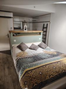a bed with two pillows on it in a room at La Casa Beaujolaise in Charnay