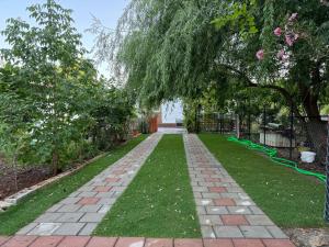 a garden with a brick pathway and trees at Fethiye Çiftlik Villa in Fethiye