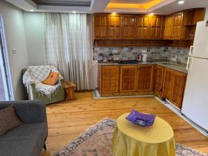 a kitchen with a couch and a table in a room at Fethiye Çiftlik Villa in Fethiye