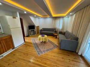 a living room with a couch and a table at Fethiye Çiftlik Villa in Fethiye