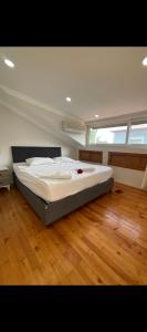 a large bed in a room with a wooden floor at Fethiye Çiftlik Villa in Fethiye +19 photos