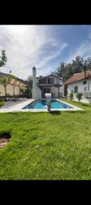a house with a swimming pool in the yard at Fethiye Çiftlik Villa in Fethiye