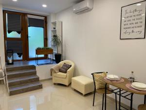 a living room with a table and chairs and a dining room at GlamByAJ with free parking and Netflix in Pula
