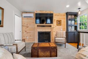 a living room with a fireplace and a tv at Private Home Great Location Dog Friendly in Provincetown