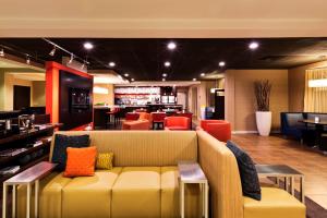 a lobby with a couch and chairs and a bar at Courtyard Mishawaka-University Area in South Bend