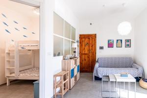 a living room with a couch and a table at Casada's House in Alghero +48 photos