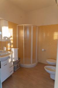 a bathroom with two sinks and a shower at Appartamento la strea in Torre Squillace +11 photos