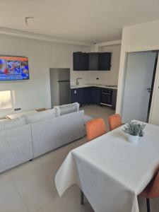 a living room with a table and a couch at T3 rdc mimosas in Juvignac
