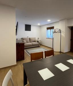 a living room with a table and a couch at Casa ROSAMUNDA con gran jardín y cerca del mar in Santander +9 photos