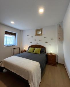 a bedroom with a large bed and two night stands at Casa ROSAMUNDA con gran jardín y cerca del mar in Santander