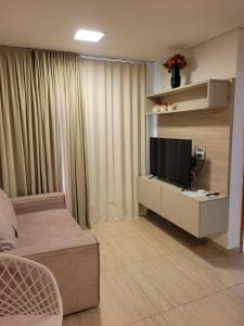 a living room with a television on a white cabinet at Sol morena 1 in Conde