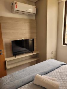 a bedroom with a flat screen tv on a wall at Sol morena 1 in Conde +17 photos