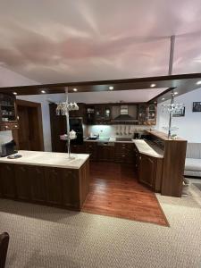 a large kitchen with a island in the middle at Apartmán Štěpánkův Pivovar in Jemnice +14 photos