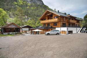 a car parked in front of a large wooden building at Apartment Alte Mühle in Scharnitz