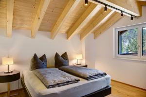 a bedroom with a bed with pillows on it at Apartment Alte Mühle in Scharnitz