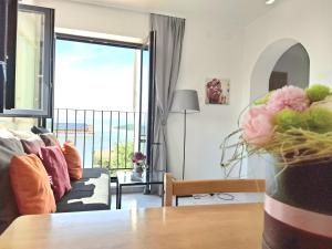 a living room with a couch and a table at Olivista Croatia Apartments in Njivice