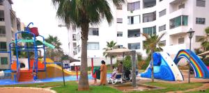 a playground in front of a large building at La Siesta Beach Resort in Mohammedia +13 photos