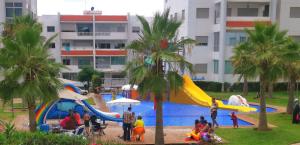 a group of people playing in a water park at La Siesta Beach Resort in Mohammedia