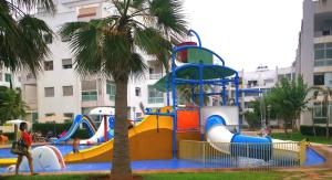 a playground in a park with a water slide at La Siesta Beach Resort in Mohammedia