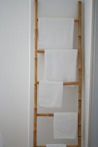a stack of white towels on a shelf in a room at HÖTEL U SANTA MARIA in Olmeto +74 photos