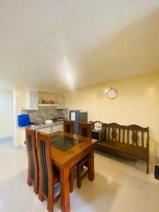 a kitchen with a wooden table in a room at The Cozy Cone in Baguio