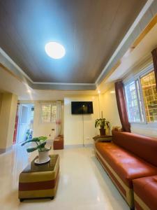 a living room with a couch and a flat screen tv at The Cozy Cone in Baguio +2 photos