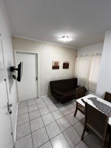 a living room with a couch and a table at AP 100m do mar mesma rua do Quiosque VavaZão in Capão da Canoa +12 photos