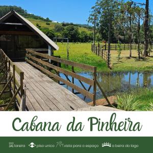 a wooden bridge over a pond in a field at Cabanas Bela Vista in Rolante