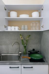 a kitchen counter with a sink and a bowl on it at Hotel Estetico Boutique by KeyGo in Yerevan +28 photos