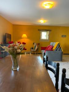 a living room with a table and a couch at Domaine Léa Chanflaur - Spa - La maison du bonheur in Terraube