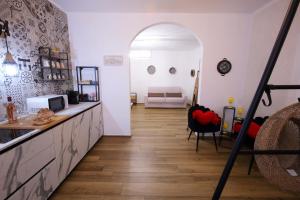 a living room with a wooden floor and an archway at La Macchia sui Sassi in Matera +33 photos