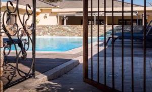 a fence with a pool in front of a building at Studio dans résidence avec piscine à Sisco in Sisco