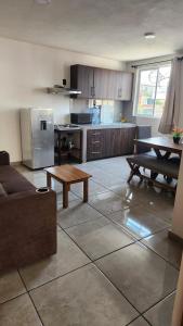 a kitchen with a couch and a table in a room at Departamento Garcis in Morelia
