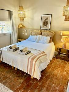 a bedroom with a large bed with towels on it at MAISON NOMADE Valbonne in Valbonne +15 photos