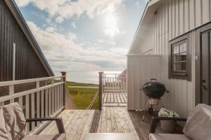 a porch with a view of the ocean on a house at Äleklinta in Äleklinta