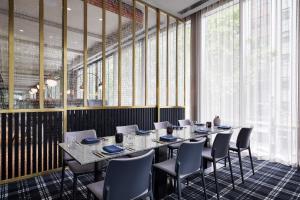 a dining room with a long table and chairs at W Melbourne in Melbourne