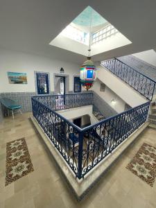 a spiral staircase with a sink in a room at Dar Sandra Bizerte in Bizerte