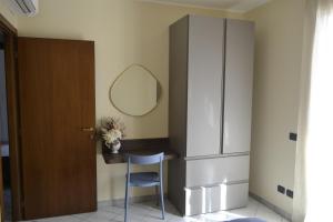 a dressing room with a table and a mirror at Appartamento Camineve 1 in Loano