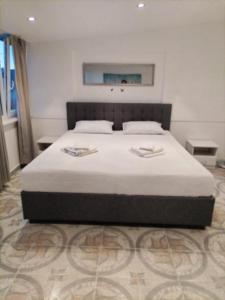 a bedroom with a large bed with white sheets at Apartmani Punta in Zadar