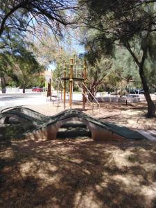 a playground in a park with a slide at Apartmani Punta in Zadar