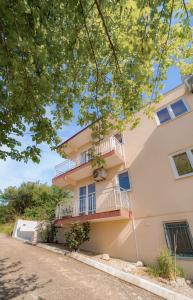 a building with balconies and trees at Villa Katharina in Utjeha +9 photos