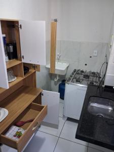 a small kitchen with a stove and a sink at Apartamento Premium Grand Luxo in Fortaleza